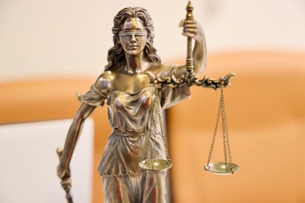 Statue of the scales of justice on a desk